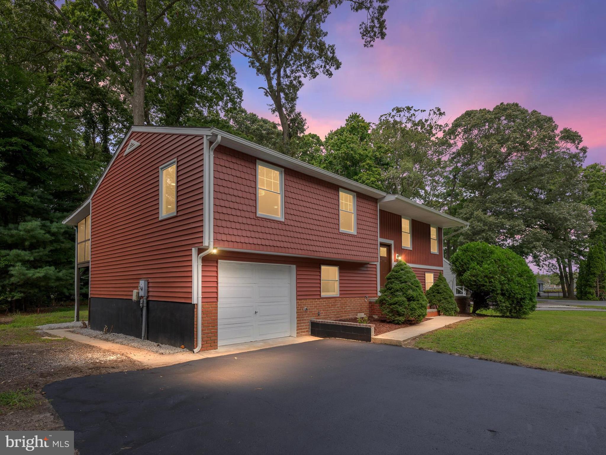22832 Angola Road East Lewes, DE 19958 - Photo 2 of 43 a front view of a house with a yard and garage