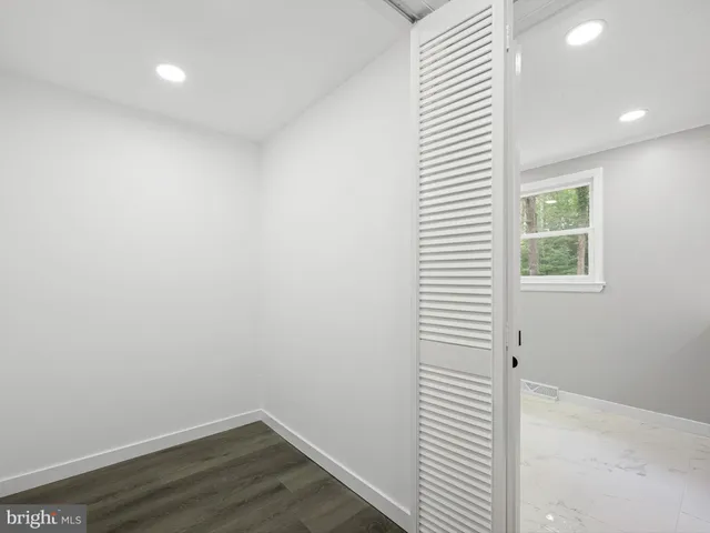 a view of a room with wooden floor and a window
