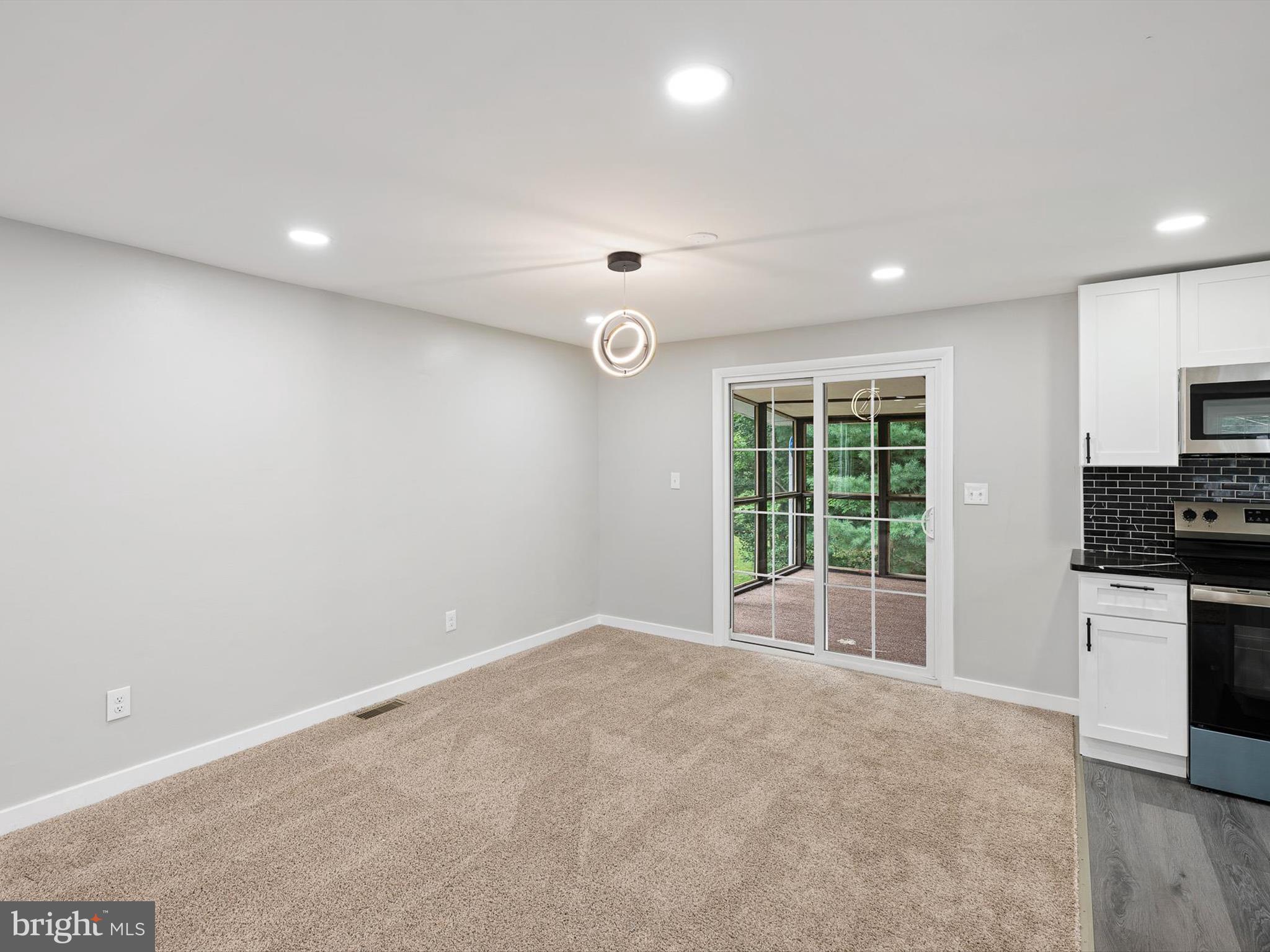22832 Angola Road East Lewes, DE 19958 - Photo 30 of 43 a view of an empty room with a window and a kitchen