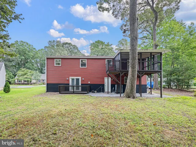a view of a house with a yard and sitting area