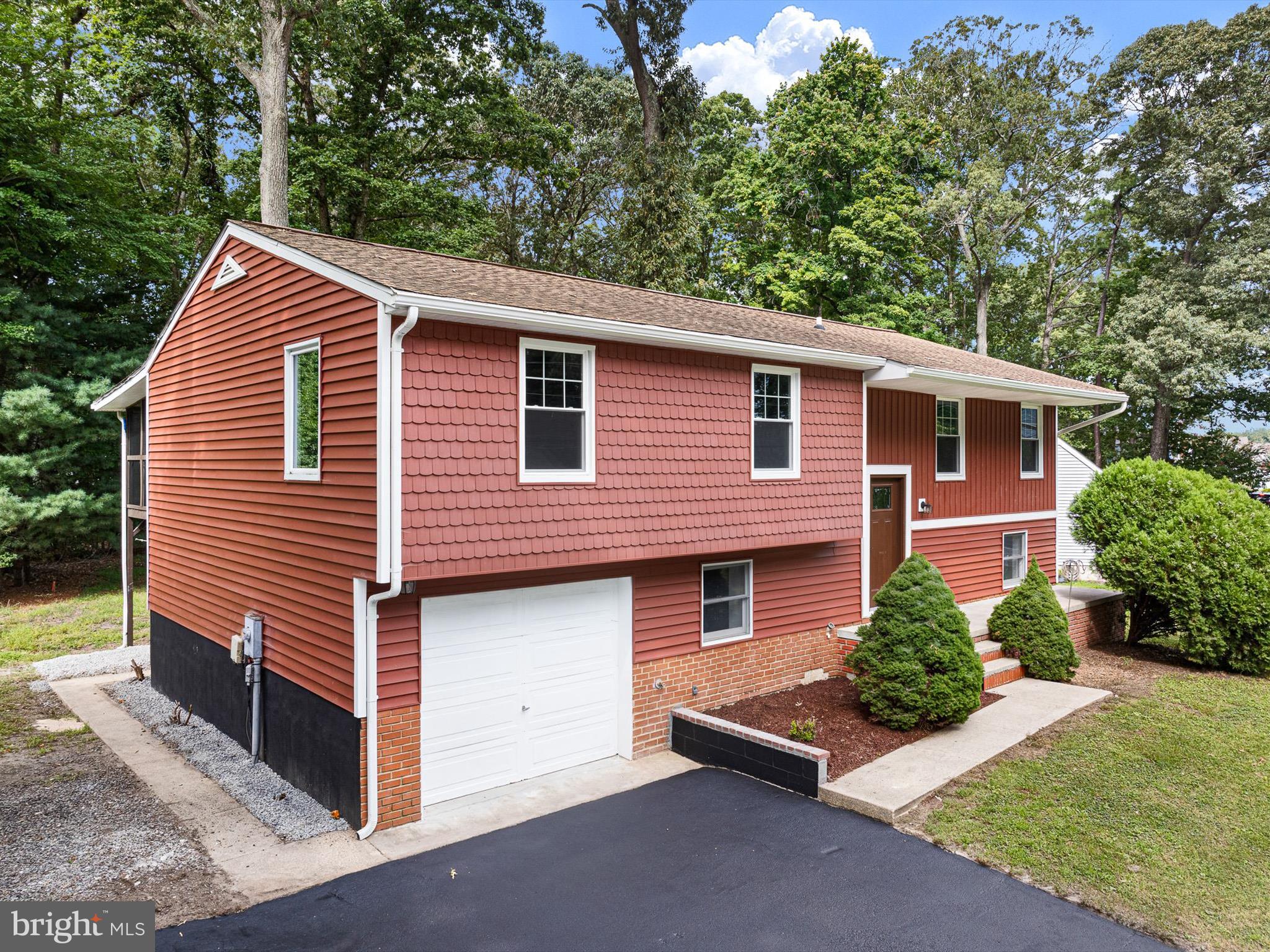 22832 Angola Road East Lewes, DE 19958 - Photo 36 of 43 a front view of a house with a yard
