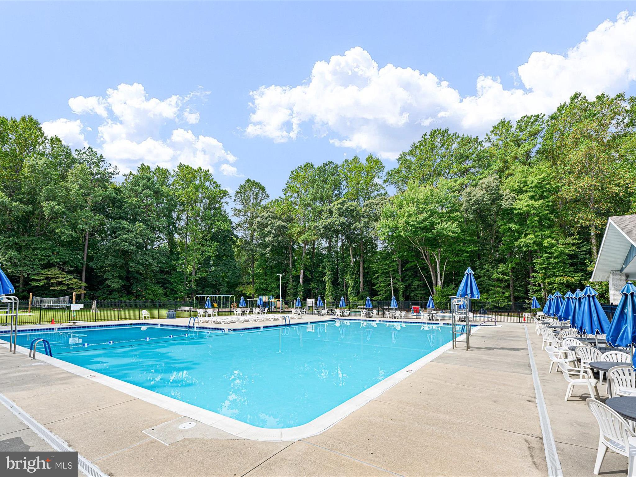 22832 Angola Road East Lewes, DE 19958 - Photo 38 of 43 a view of a swimming pool with an outdoor space and seating area