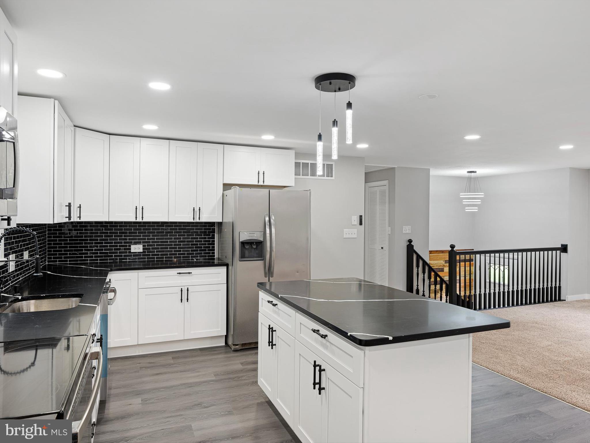 22832 Angola Road East Lewes, DE 19958 - Photo 4 of 43 a kitchen with granite countertop a stove and a refrigerator