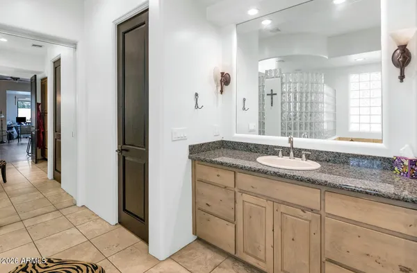 a bathroom with a granite countertop sink and a mirror