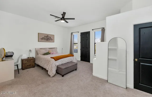 a living room with furniture and a ceiling fan