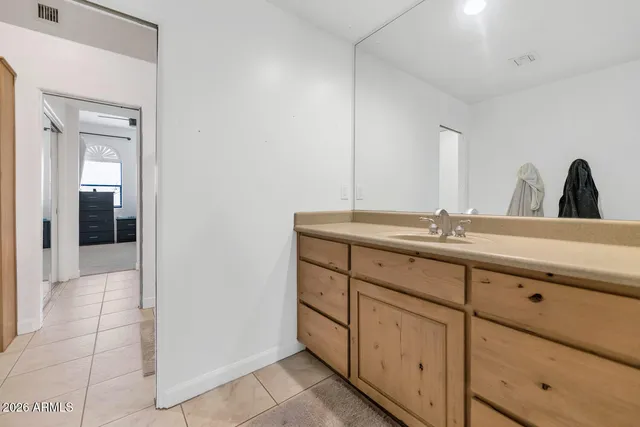 a bathroom with a double vanity sink and mirror