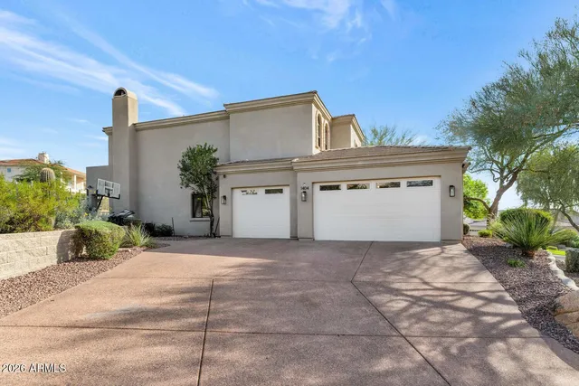 a view of a house with a garage and a fire pit