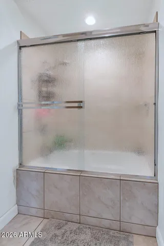 a bathroom with a glass shower door