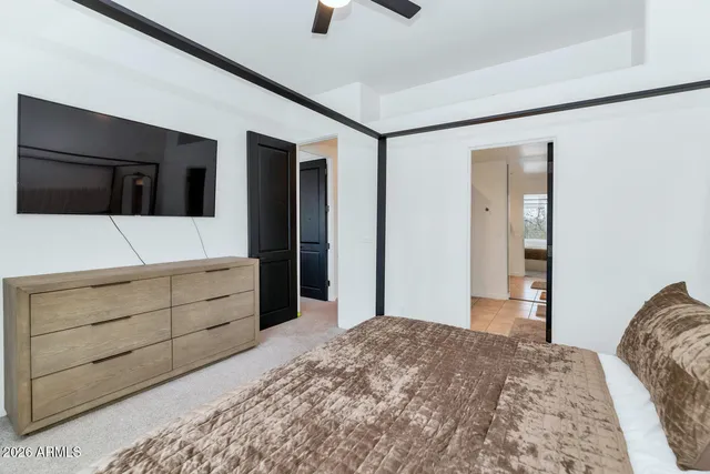 a bedroom with a bed and a flat screen tv