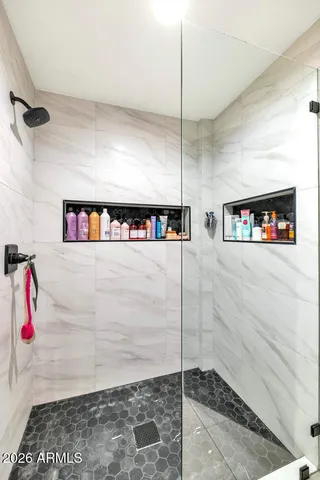 a view of a hallway with a glass door shower