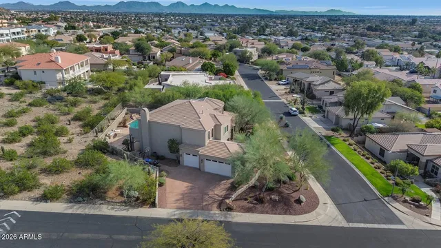 an aerial view of a house with a yard basket ball court and outdoor seating