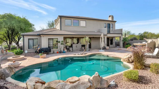a view of a house with swimming pool and sitting area