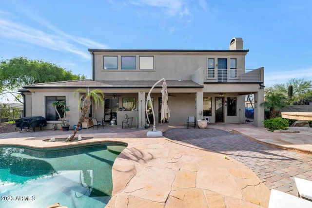 a view of house with outdoor seating area and furniture