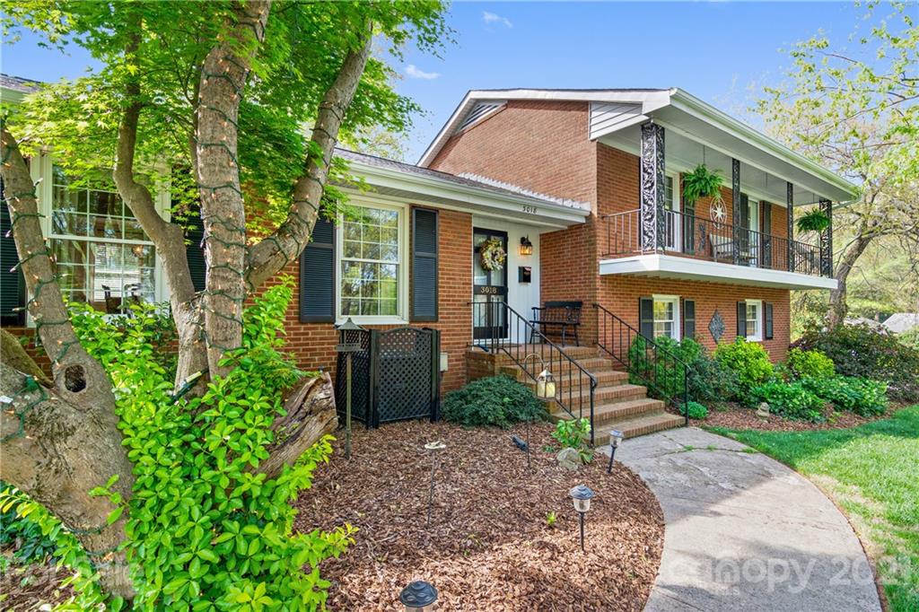 a front view of a house with garden and porch