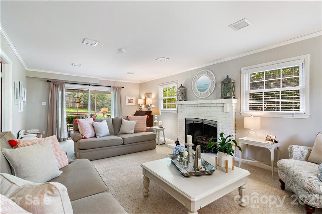 3018 Goneaway Road Charlotte, NC 28210 - Photo 13 of 35 a living room with furniture a fireplace and a large window