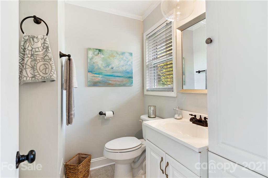 3018 Goneaway Road Charlotte, NC 28210 - Photo 18 of 35 a bathroom with a toilet sink and mirror