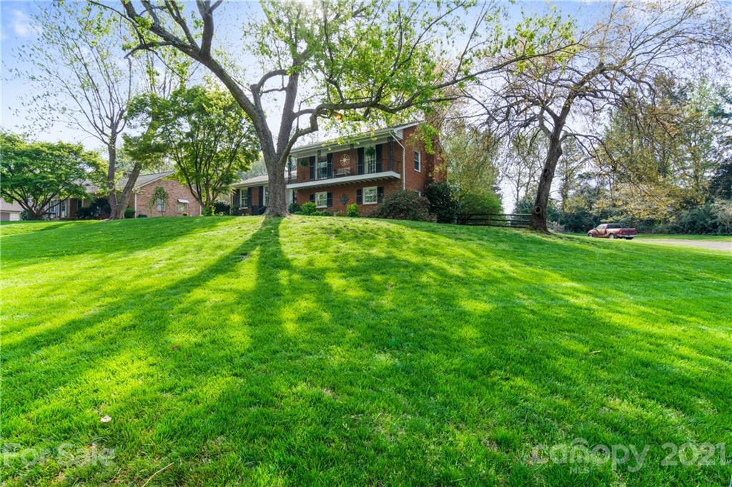 3018 Goneaway Road Charlotte, NC 28210 - Photo 3 of 35 a view of a trees in front of a brick house