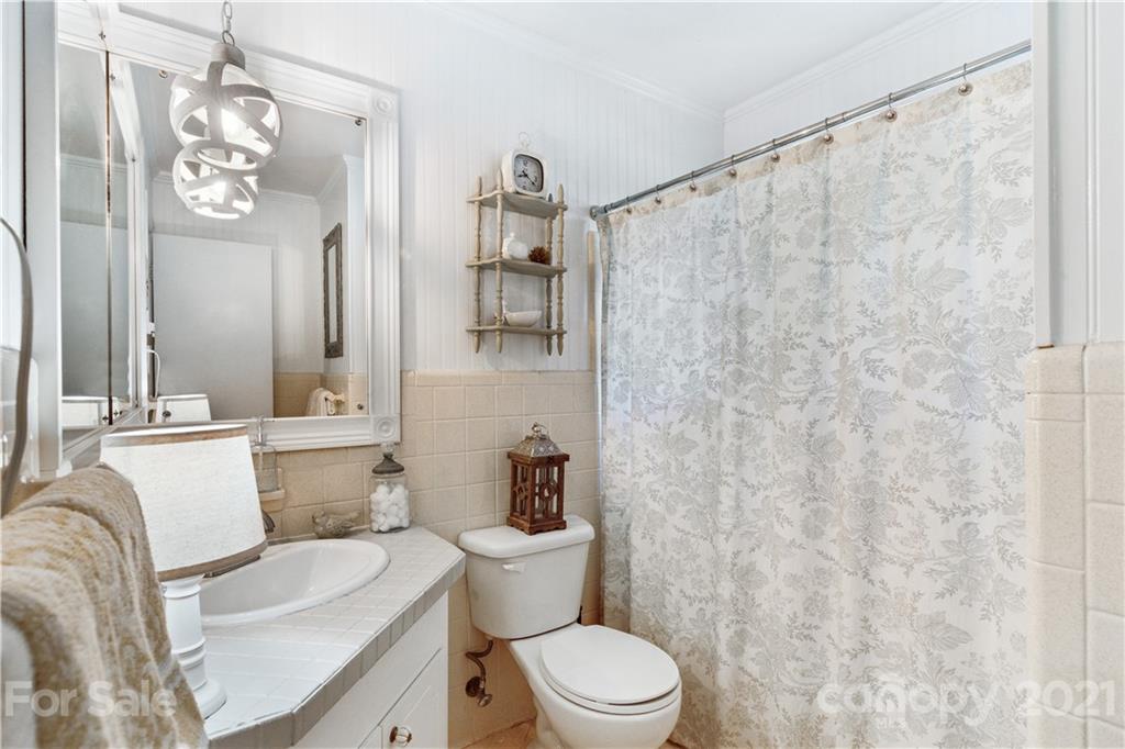 3018 Goneaway Road Charlotte, NC 28210 - Photo 23 of 35 a white toilet sitting next to a bathroom sink