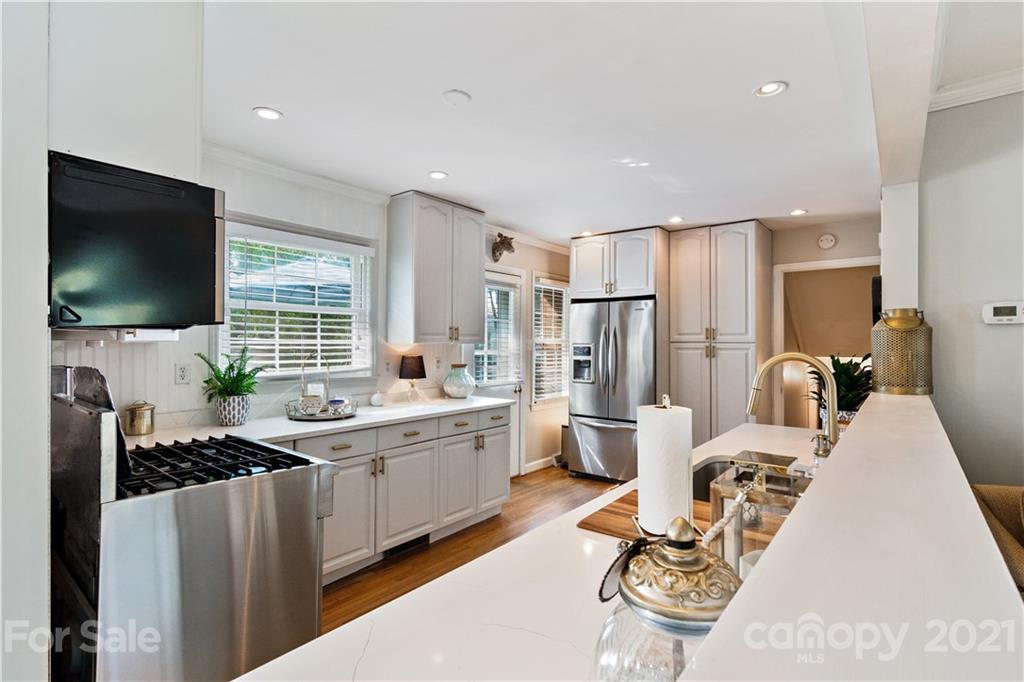 3018 Goneaway Road Charlotte, NC 28210 - Photo 5 of 35 a living room with furniture a flat screen tv and a refrigerator