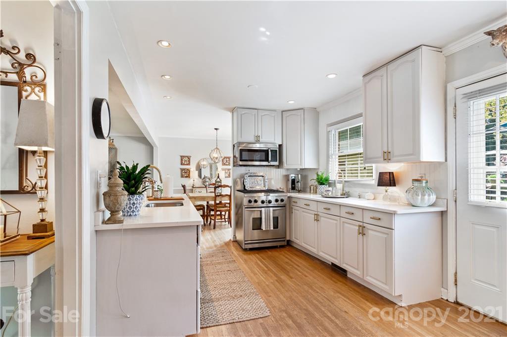 3018 Goneaway Road Charlotte, NC 28210 - Photo 6 of 35 a kitchen with a sink stove cabinets and refrigerator