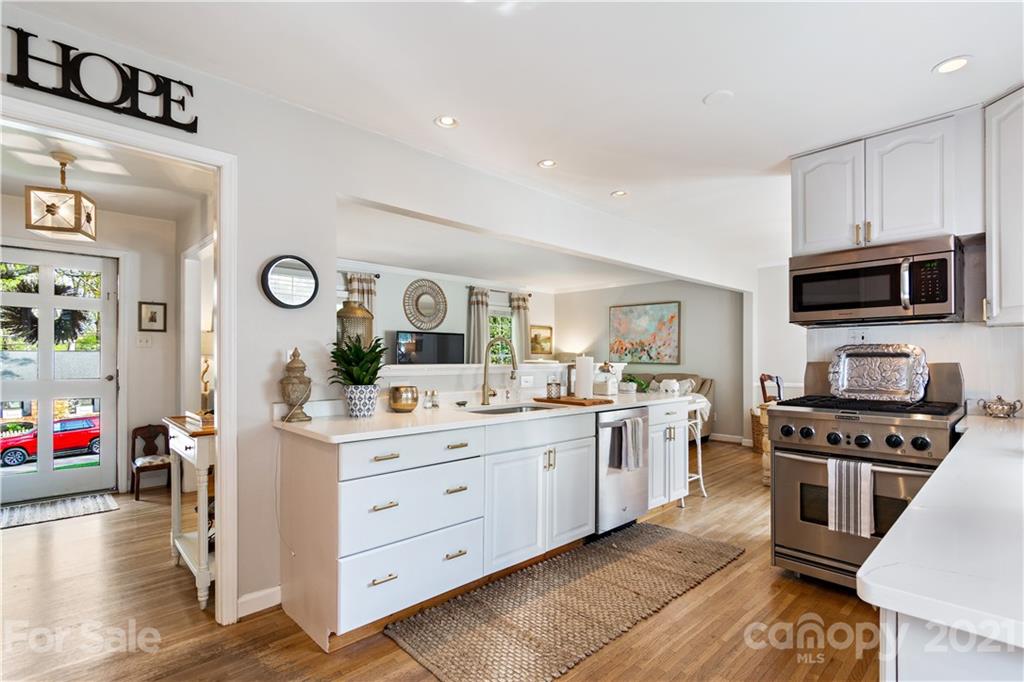 3018 Goneaway Road Charlotte, NC 28210 - Photo 7 of 35 a kitchen with a sink cabinets and wooden floor