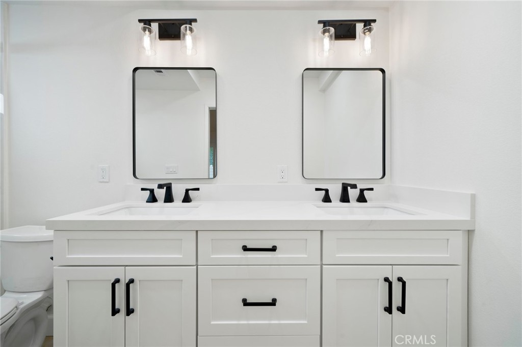 5408 Hanover Drive Cypress, CA 90630 - Photo 17 of 33 a bathroom with double vanity sink and mirror