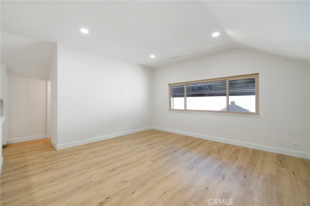 5408 Hanover Drive Cypress, CA 90630 - Photo 19 of 33 an empty room with wooden floor and windows