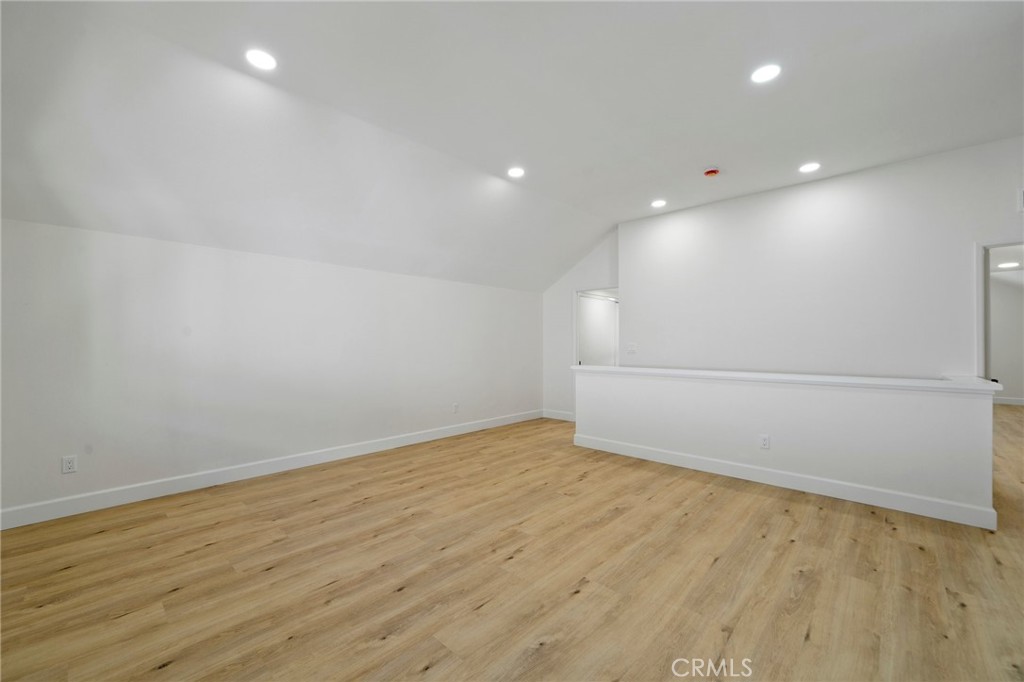 5408 Hanover Drive Cypress, CA 90630 - Photo 20 of 33 an empty room with wooden floor and white walls