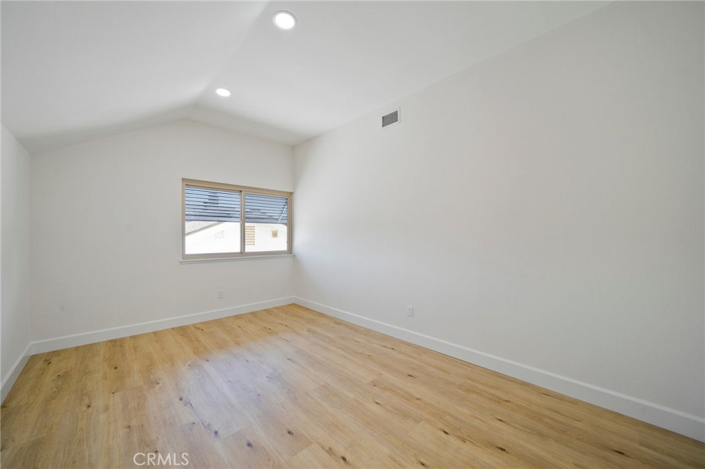 5408 Hanover Drive Cypress, CA 90630 - Photo 21 of 33 an empty room with wooden floor and windows
