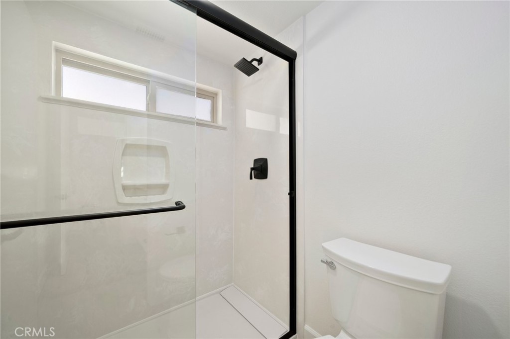 5408 Hanover Drive Cypress, CA 90630 - Photo 26 of 33 a bathroom with a shower and a toilet