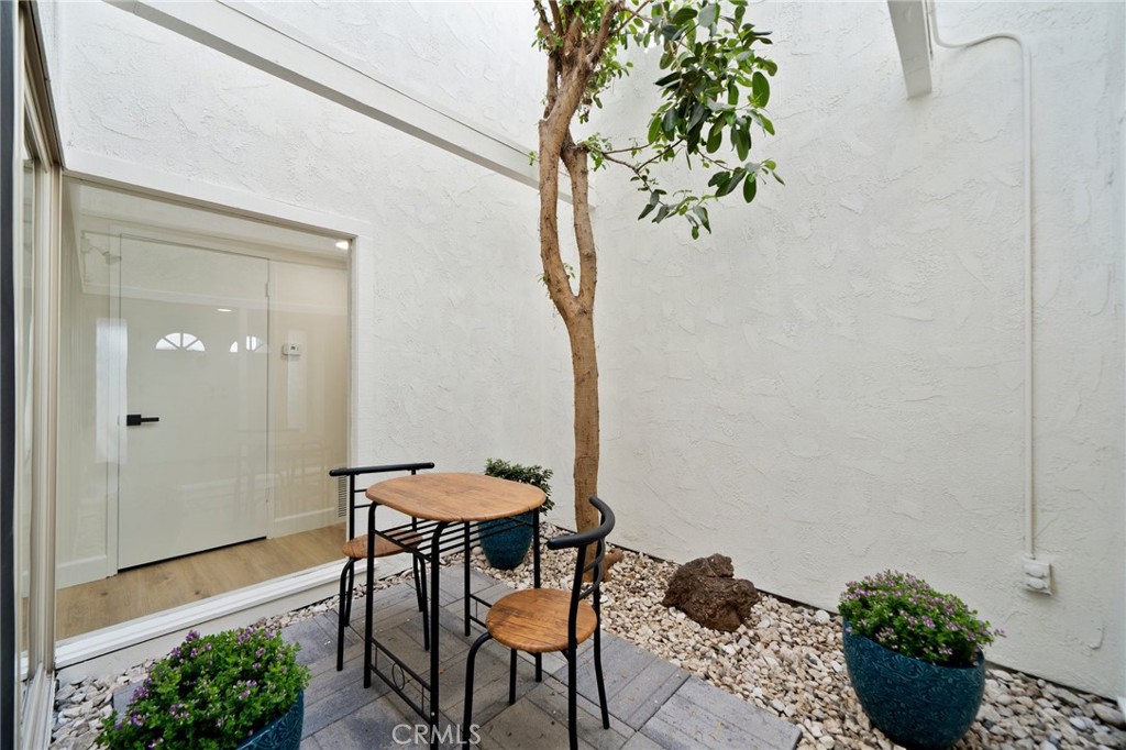 5408 Hanover Drive Cypress, CA 90630 - Photo 31 of 33 a view of a balcony with table and chairs potted plants