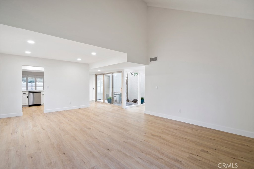5408 Hanover Drive Cypress, CA 90630 - Photo 7 of 33 a view of an empty room with wooden floor and a window