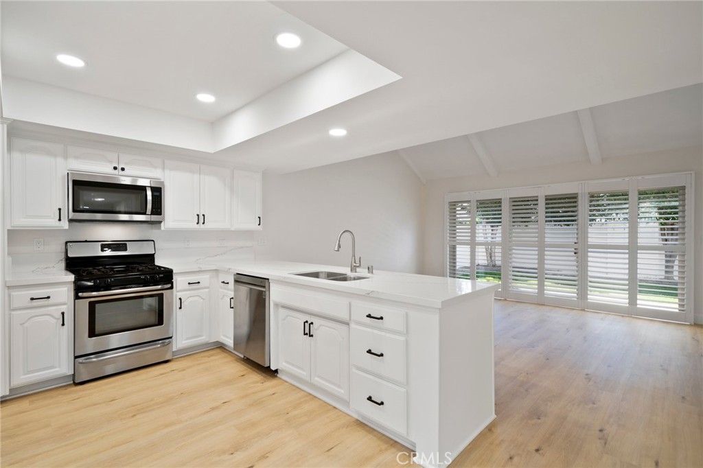 5408 Hanover Drive Cypress, CA 90630 - Photo 8 of 33 a kitchen with stainless steel appliances granite countertop a stove and a sink