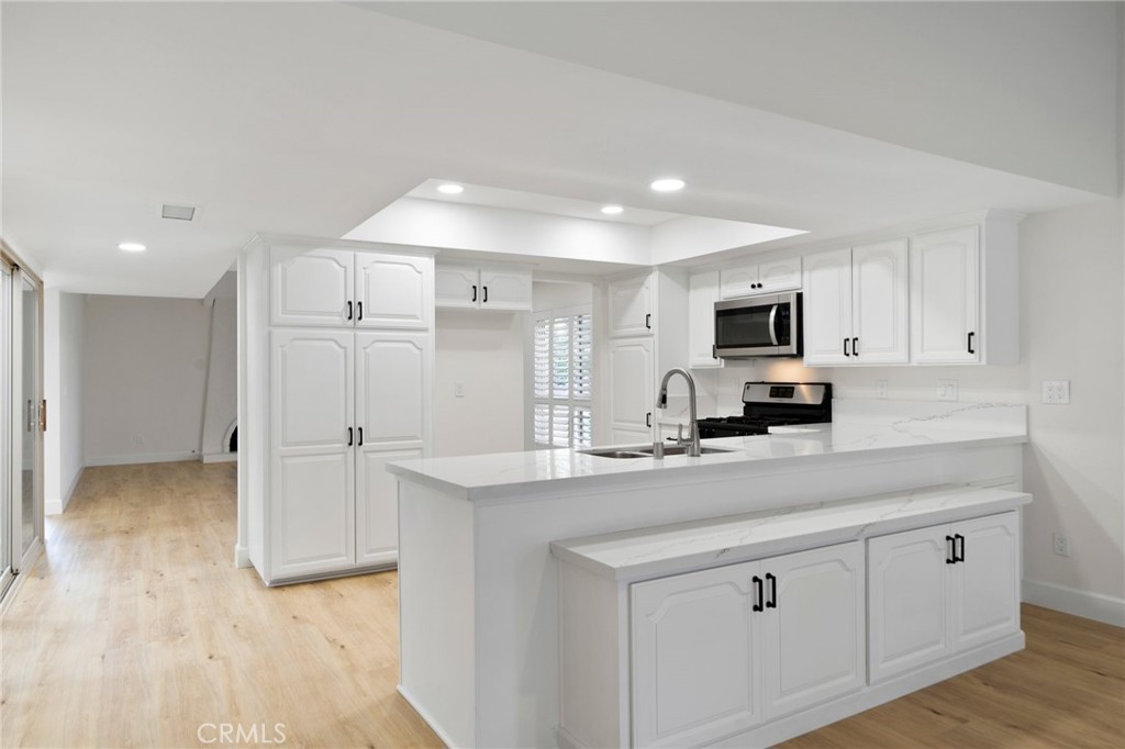 5408 Hanover Drive Cypress, CA 90630 - Photo 9 of 33 a kitchen with appliances a sink and cabinets