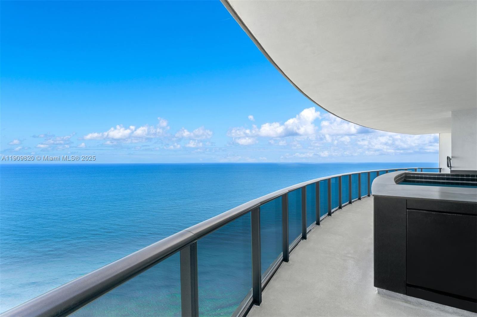 18555 Collins Avenue, Unit 3205 Sunny Isles Beach, FL 33160 - Photo 1 of 50 a view of balcony with furniture