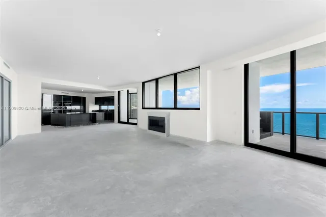 a view of a livingroom with furniture and kitchen