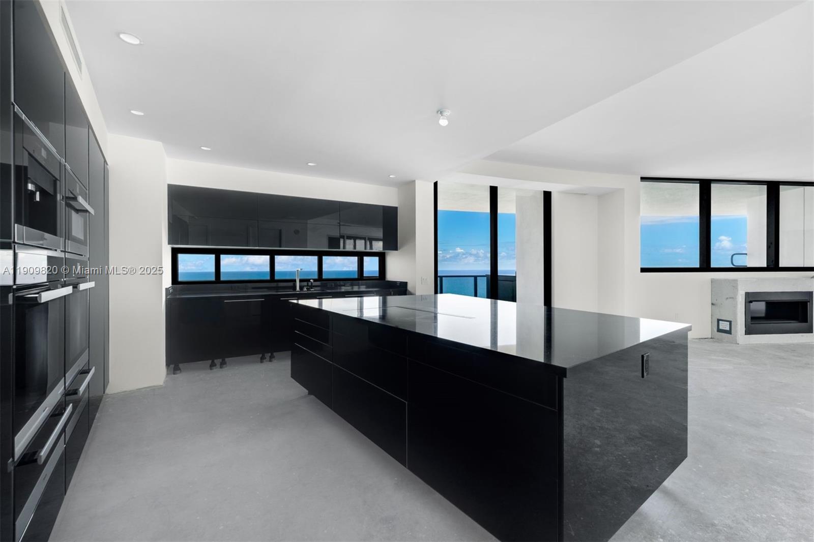 18555 Collins Avenue, Unit 3205 Sunny Isles Beach, FL 33160 - Photo 18 of 50 a large kitchen with stainless steel appliances a large counter top