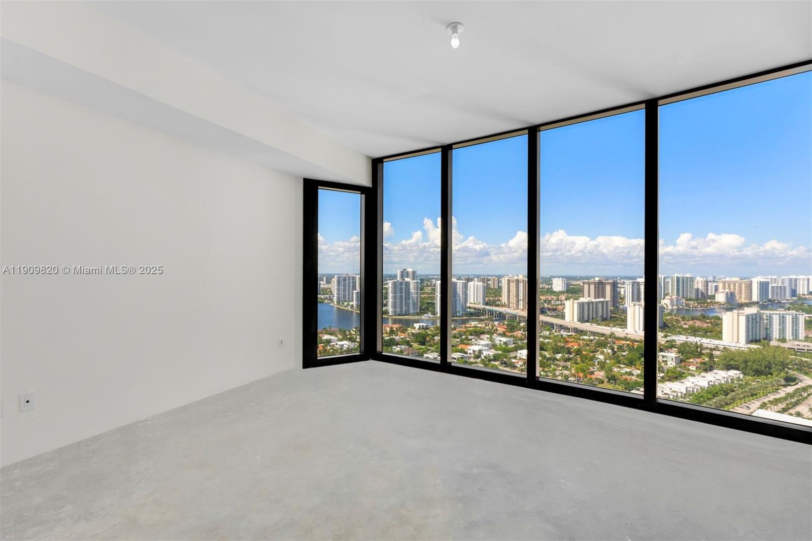 18555 Collins Avenue, Unit 3205 Sunny Isles Beach, FL 33160 - Photo 35 of 50 a view of an empty room with a large window