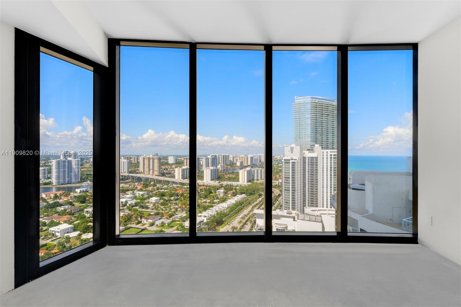 18555 Collins Avenue, Unit 3205 Sunny Isles Beach, FL 33160 - Photo 36 of 50 a view of a city from a living room