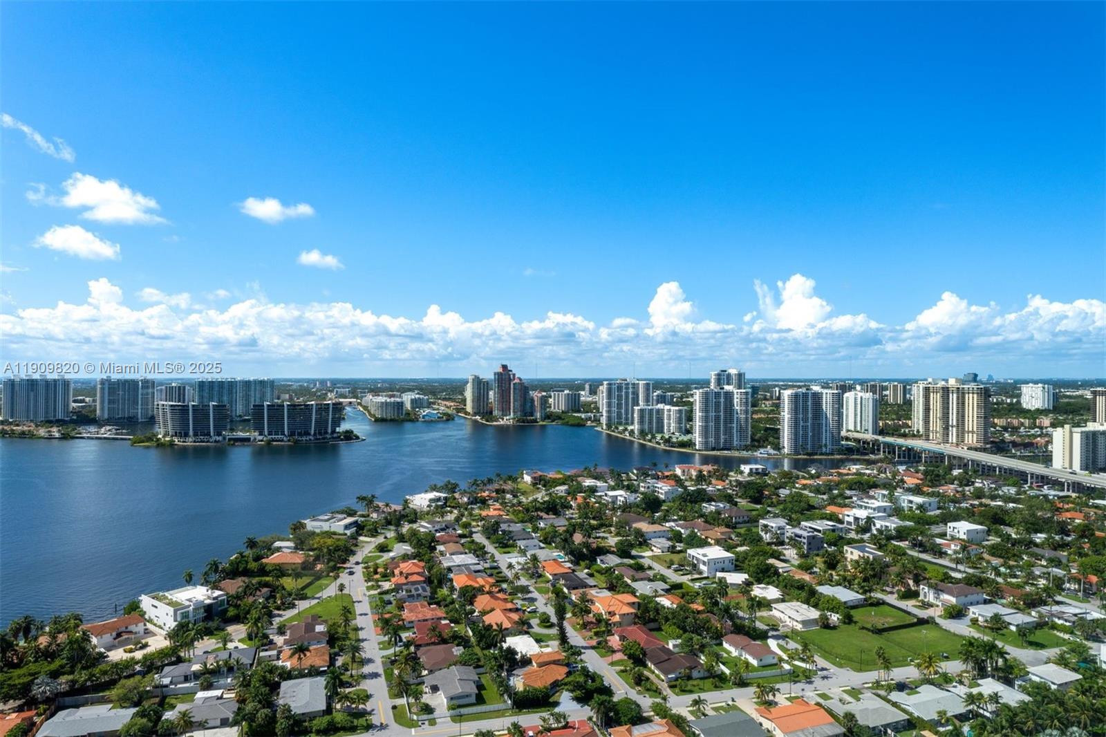 18555 Collins Avenue, Unit 3205 Sunny Isles Beach, FL 33160 - Photo 38 of 50 an aerial view of a house with a garden and lake view