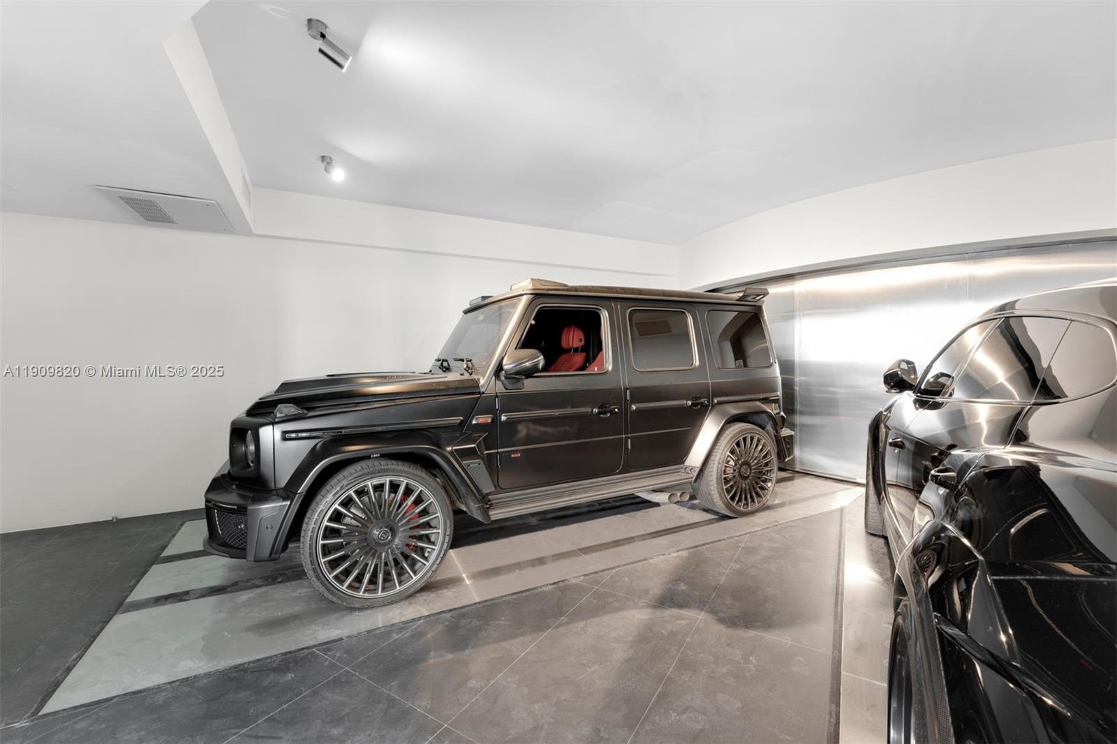 18555 Collins Avenue, Unit 3205 Sunny Isles Beach, FL 33160 - Photo 46 of 50 a car is parked in a garage