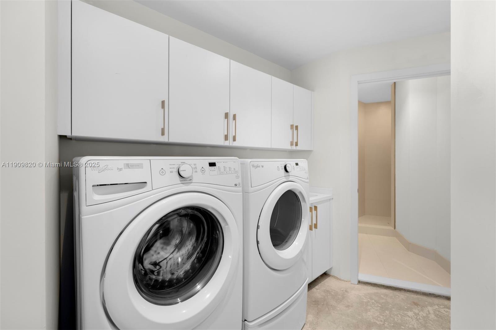 18555 Collins Avenue, Unit 3205 Sunny Isles Beach, FL 33160 - Photo 48 of 50 a utility room with dryer and washer