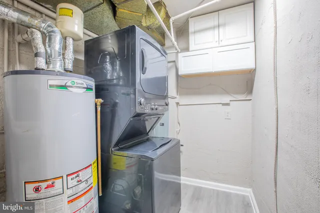 a brick house with a big yard and large trees