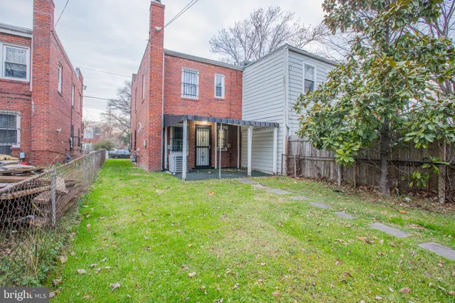 a backyard of a house with a fountain