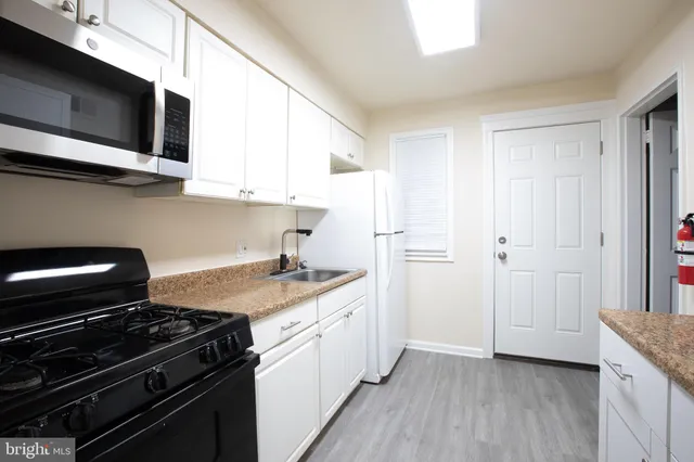 a kitchen with a stove and a microwave