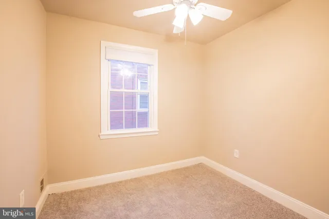 an empty room with a ceiling fan