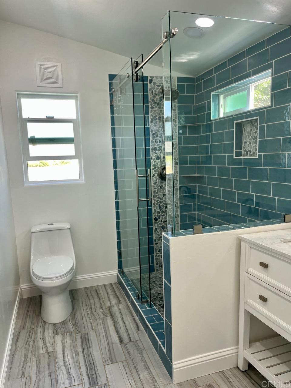 9902 Jamacha Boulevard, Unit 160 Spring Valley, CA 91977 - Photo 9 of 18 a bathroom with a sink a toilet and shower