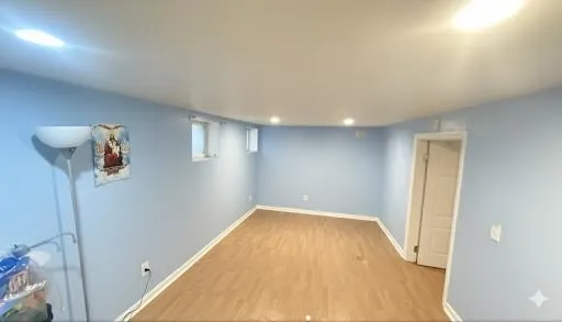 a view of a room with wooden floor and a hallway