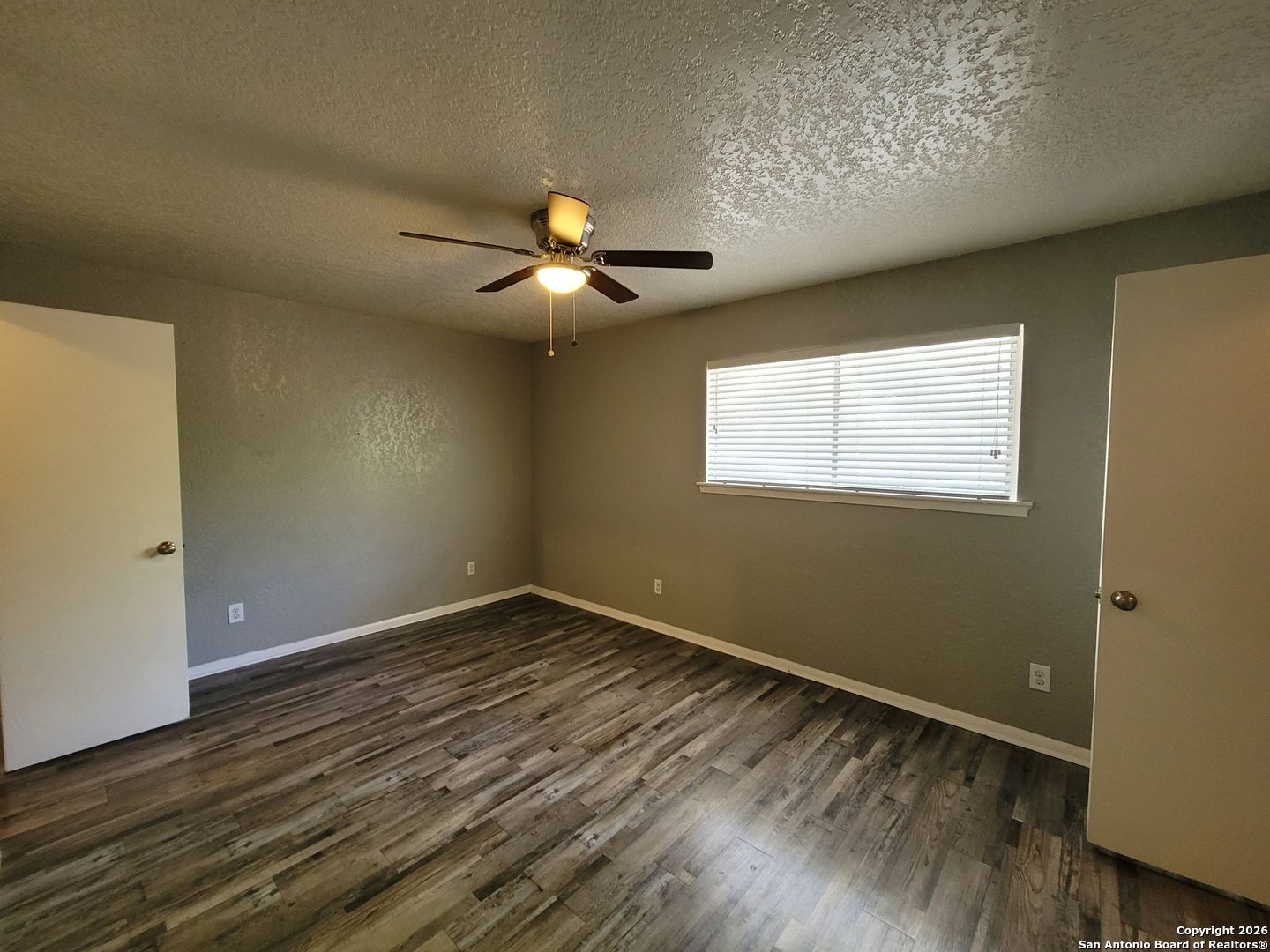 516 Gentleman Road, Unit 17 Balcones Heights, TX 78201 - Photo 7 of 29 an empty room with wooden floor and windows