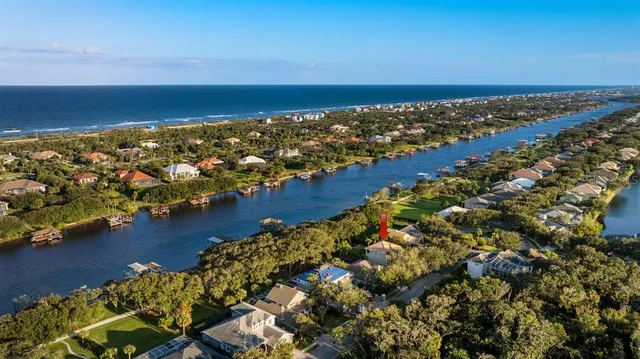 a sign board with a small yard and palm trees
